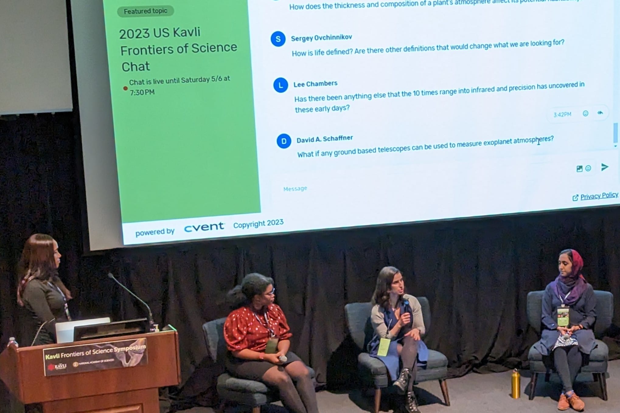 A diverse group of individuals seated on chairs in front of a screen, engaged in a presentation.