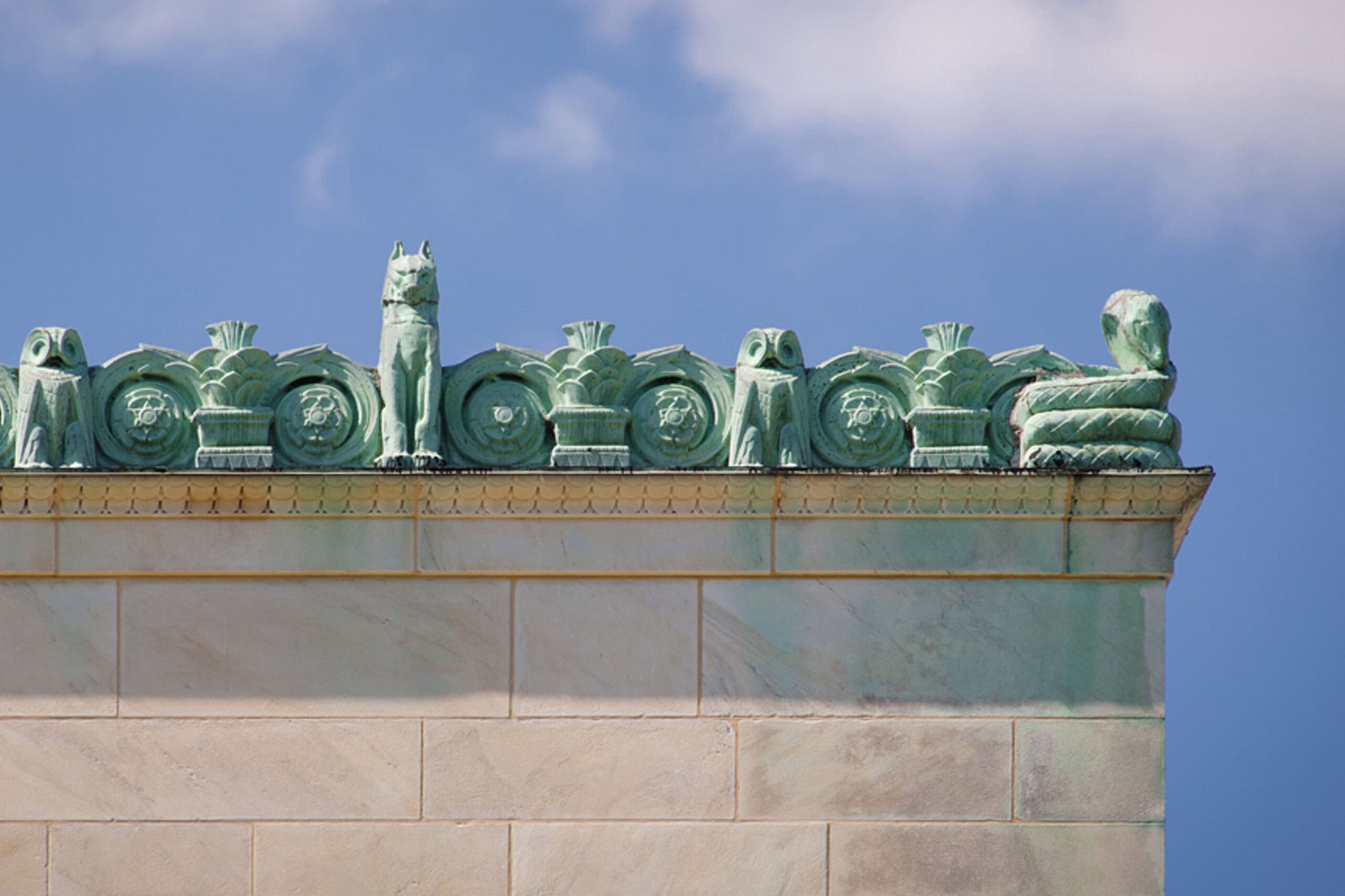Rooftop of building adorned with statues.
