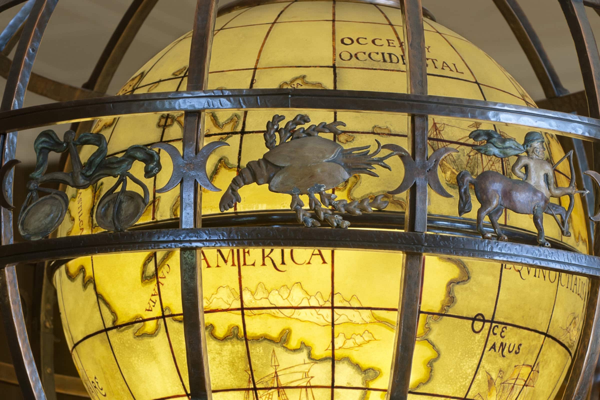 A globe with a map on it, displaying continents, countries, and oceans.