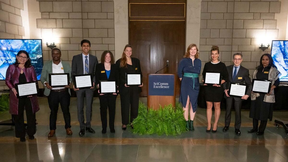 A diverse group of individuals proudly displaying certificates